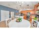 Open-concept kitchen and dining area are adjacent and feature modern appliances and stylish light fixtures at 5720 107Th E Ter, Parrish, FL 34219