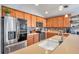Updated kitchen featuring stainless steel appliances, wood cabinets, ample counter space, and stylish backsplash at 5720 107Th E Ter, Parrish, FL 34219