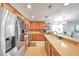 Modern kitchen design with stainless steel appliances, wood cabinets, tiled backsplash, and an eat-in dining area at 5720 107Th E Ter, Parrish, FL 34219