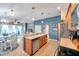 Open-concept kitchen area with stainless steel appliances, wood cabinets, tiled flooring, and an eat-in dining area at 5720 107Th E Ter, Parrish, FL 34219