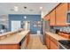 Well-lit kitchen with stainless appliances, double sink, wood cabinets, and spacious countertops at 5720 107Th E Ter, Parrish, FL 34219