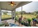 Screened lanai with ceiling fan, ample seating and views of the pond and backyard at 5720 107Th E Ter, Parrish, FL 34219