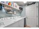 Laundry room with washer, dryer, shelving and storage, and access to the garage at 5720 107Th E Ter, Parrish, FL 34219
