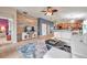 Open-concept living room flows into the kitchen with tile floors and a decorative wood accent wall at 5720 107Th E Ter, Parrish, FL 34219