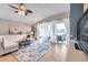 Bright living room features tile floors, ceiling fan and sliding glass doors to the outdoor patio at 5720 107Th E Ter, Parrish, FL 34219