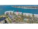 Stunning aerial view of waterfront condos featuring lush landscaping, a pool, and serene ocean vistas, perfect coastal living at 6093 Bahia Del Mar Cir # 375, St Petersburg, FL 33715