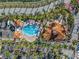 Aerial view of a community pool with palm trees and lounge chairs at 6093 Bahia Del Mar Cir # 375, St Petersburg, FL 33715