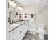 Bathroom with a double vanity, modern fixtures, and granite countertops offers a clean and stylish design at 6093 Bahia Del Mar Cir # 375, St Petersburg, FL 33715