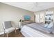 Comfortable bedroom with sliding glass doors to the balcony, dresser with TV, and contemporary decor at 6093 Bahia Del Mar Cir # 375, St Petersburg, FL 33715