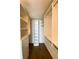 Organized walk-in closet featuring hardwood floors, custom shelving and plenty of hanging storage space at 6093 Bahia Del Mar Cir # 375, St Petersburg, FL 33715