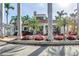 Stunning clubhouse exterior featuring a terracotta roof, lush landscaping, and picturesque palm trees at 6093 Bahia Del Mar Cir # 375, St Petersburg, FL 33715