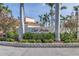Beautiful community sign amidst lush landscaping and palm trees, showcasing the entrance to the neighborhood at 6093 Bahia Del Mar Cir # 375, St Petersburg, FL 33715