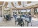 Elegant dining area with decorative chairs, tiled floor, and views of the pool at 6093 Bahia Del Mar Cir # 375, St Petersburg, FL 33715