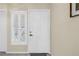 Clean entryway with a white door, shuttered window, neutral paint and grey tile floor at 6093 Bahia Del Mar Cir # 375, St Petersburg, FL 33715