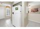 Hallway featuring a refrigerator, and views of the entryway and modern lighting at 6093 Bahia Del Mar Cir # 375, St Petersburg, FL 33715