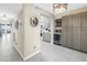 Hallway leading to kitchen with modern cabinetry, wine fridge, and bar shelving at 6093 Bahia Del Mar Cir # 375, St Petersburg, FL 33715