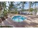 Community hot tub surrounded by tropical landscaping and lounging chairs at 6093 Bahia Del Mar Cir # 375, St Petersburg, FL 33715