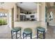 Kitchen with bar seating, white cabinetry, stainless steel appliances and granite countertops at 6093 Bahia Del Mar Cir # 375, St Petersburg, FL 33715