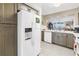Bright kitchen featuring a stainless steel refrigerator, dishwasher and view to the living area at 6093 Bahia Del Mar Cir # 375, St Petersburg, FL 33715