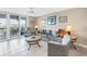 Cozy living room with a waterfront view and a comfortable seating arrangement with a ceiling fan at 6093 Bahia Del Mar Cir # 375, St Petersburg, FL 33715