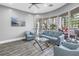 Modern lounge area with stylish blue sofas, floor-to-ceiling windows, and comfortable seating at 6093 Bahia Del Mar Cir # 375, St Petersburg, FL 33715