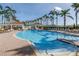 Large community pool surrounded by swaying palm trees and plenty of seating at 6093 Bahia Del Mar Cir # 375, St Petersburg, FL 33715