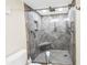 Walk-in shower featuring gray tile surround, glass door, built-in bench, and modern fixtures at 6093 Bahia Del Mar Cir # 375, St Petersburg, FL 33715