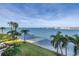 Beautiful waterfront view with palm trees and lush grass at 6093 Bahia Del Mar Cir # 375, St Petersburg, FL 33715