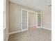 Neutral room featuring wood-look tile flooring and double glass doors leading to another room at 2416 Wise River Ln, Zephyrhills, FL 33541