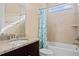 Bright bathroom featuring a tiled shower and tub combination, granite countertop vanity, and large window for natural light at 28475 Marsciano Ln, Wesley Chapel, FL 33543