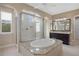 Bathroom featuring a soaking tub, walk-in shower, granite countertops, and dual sinks at 28475 Marsciano Ln, Wesley Chapel, FL 33543