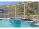 Inviting screened pool and spa with a tile surround offering a relaxing backyard retreat at 28475 Marsciano Ln, Wesley Chapel, FL 33543
