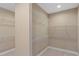 Neutral walk-in closet with ample shelving for organization at 28475 Marsciano Ln, Wesley Chapel, FL 33543
