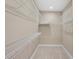 Spacious walk-in closet with ample shelving for storage and organization at 28475 Marsciano Ln, Wesley Chapel, FL 33543