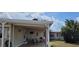 Covered outdoor area with dining set, grill, and easy access to backyard providing a shaded spot at 35138 Dale Ave, Zephyrhills, FL 33541