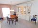 Elegant dining room with a round table, chairs, and a built-in display cabinet at 36819 Kiowa Ave, Zephyrhills, FL 33542
