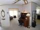 Cozy home office featuring a wooden desk and cabinet, with living room access at 36819 Kiowa Ave, Zephyrhills, FL 33542