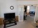 Inviting living room with television, leading to the dining room and kitchen at 36819 Kiowa Ave, Zephyrhills, FL 33542