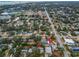 Aerial view showing the house in relation to the neighborhood and nearby amenities, with an arrow marking the property at 546 Orangewood Dr, Dunedin, FL 34698