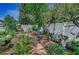 Backyard showcasing stone garden paths, lush greenery, an outdoor seating area, and vibrant landscaping at 546 Orangewood Dr, Dunedin, FL 34698