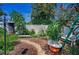 Backyard showcasing lush gardens, a bird feeder, decorative seating, and pea gravel paths at 546 Orangewood Dr, Dunedin, FL 34698