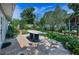 Backyard patio and lush garden at 546 Orangewood Dr, Dunedin, FL 34698