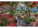 Tranquil backyard oasis featuring mature landscaping, a seating area, and privacy at 546 Orangewood Dr, Dunedin, FL 34698