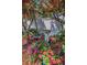 Serene backyard retreat with a wooden chair, bird bath, and colorful flowers creating a tranquil atmosphere at 546 Orangewood Dr, Dunedin, FL 34698