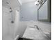Bathroom features a shower with a white curtain and a marble countertop vanity at 546 Orangewood Dr, Dunedin, FL 34698