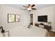 Well-lit bedroom with hard surface flooring, ceiling fan, and TV at 546 Orangewood Dr, Dunedin, FL 34698
