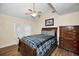 Comfortable bedroom with a vaulted ceiling, ceiling fan, and wood floors at 546 Orangewood Dr, Dunedin, FL 34698