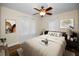 Comfortable bedroom with a ceiling fan, hardwood floors, and neutral colors at 546 Orangewood Dr, Dunedin, FL 34698