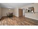 Open floor plan dining room with wood floors and close access to kitchen through pass-through window at 546 Orangewood Dr, Dunedin, FL 34698