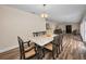 Formal dining room with marble table, six chairs, and hardwood floors leading to the living room at 546 Orangewood Dr, Dunedin, FL 34698